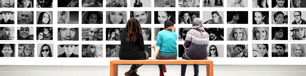 Teenagers view and discuss a photography exhibition